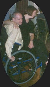 man in wheelchair, woman sitting on his lap